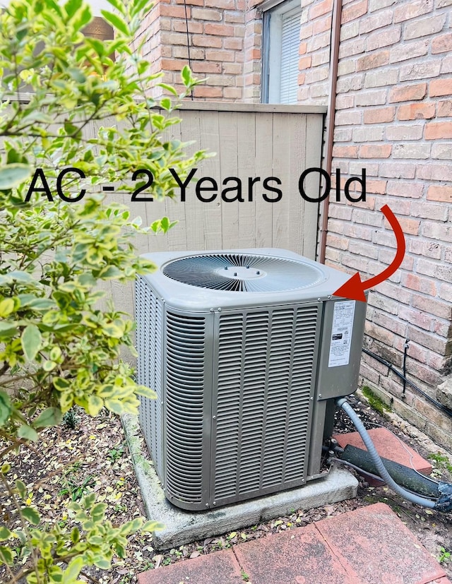 exterior details with brick siding and central air condition unit