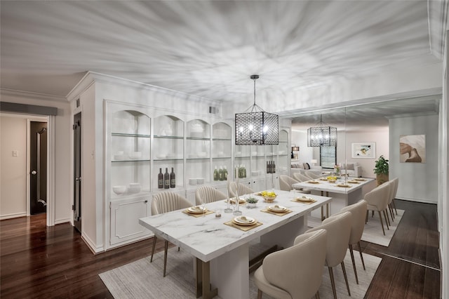 dining area featuring a notable chandelier, crown molding, and dark hardwood / wood-style floors