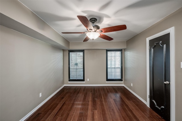 spare room with ceiling fan and dark hardwood / wood-style flooring