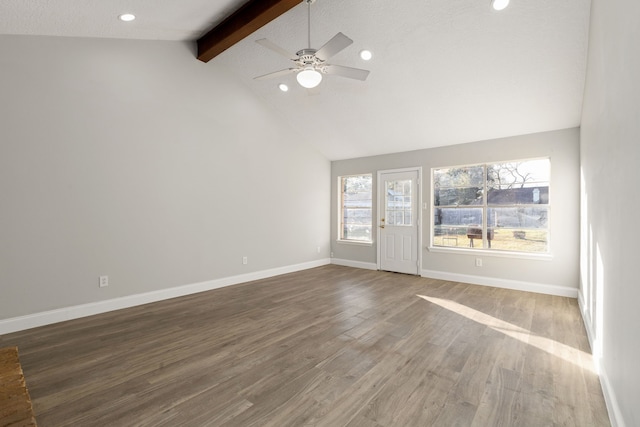 unfurnished living room featuring ceiling fan, high vaulted ceiling, dark wood-type flooring, and beam ceiling