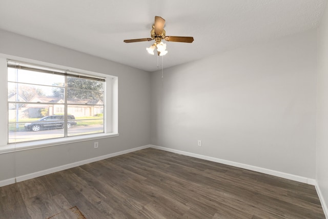 unfurnished room featuring ceiling fan and dark hardwood / wood-style floors