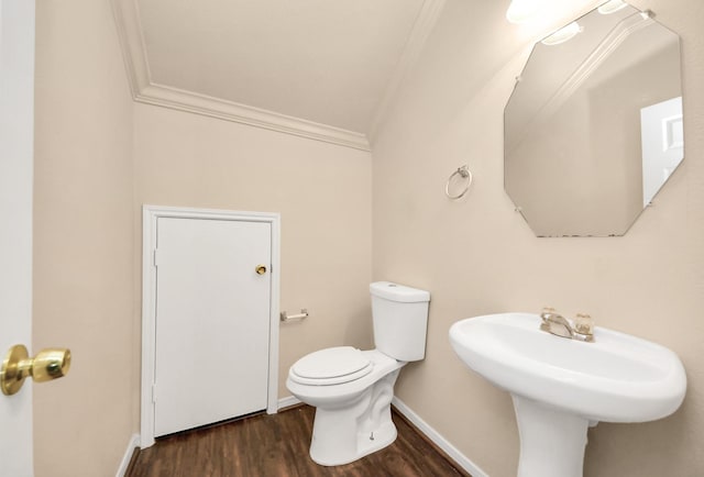 bathroom with wood-type flooring, crown molding, and toilet