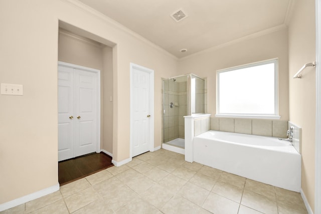 bathroom with tile patterned floors, ornamental molding, and plus walk in shower