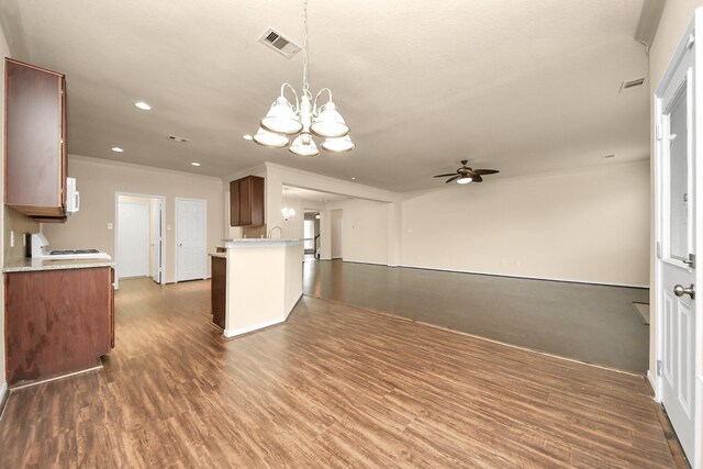 kitchen featuring hanging light fixtures, dark wood-type flooring, and ceiling fan with notable chandelier