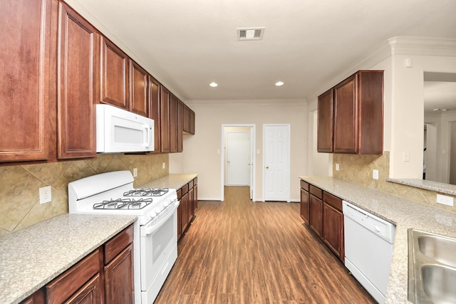 kitchen featuring white appliances, sink, backsplash, dark hardwood / wood-style floors, and crown molding