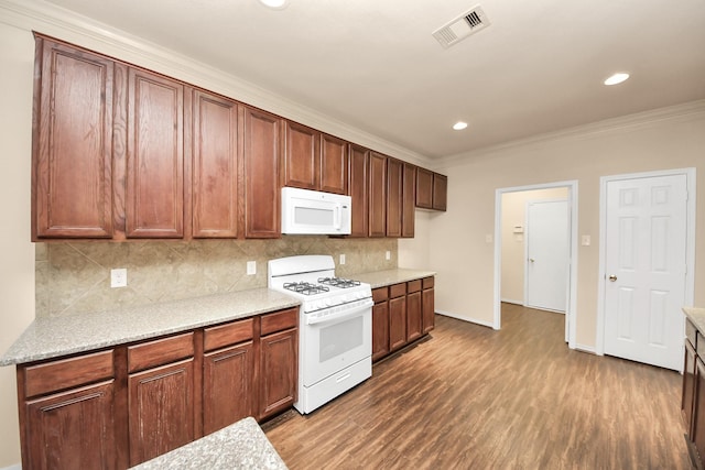 kitchen with white appliances, crown molding, dark hardwood / wood-style floors, and backsplash