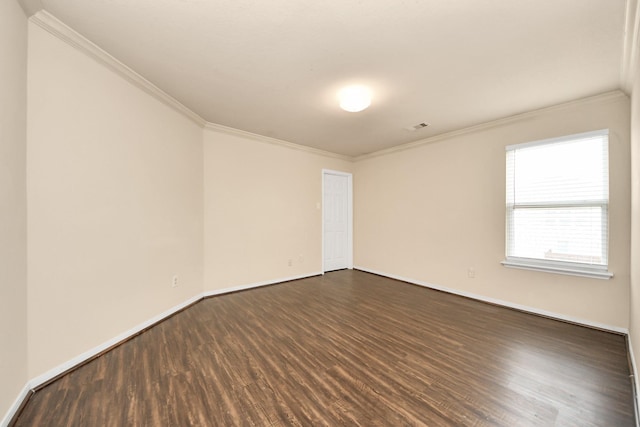 empty room with dark wood-type flooring and ornamental molding