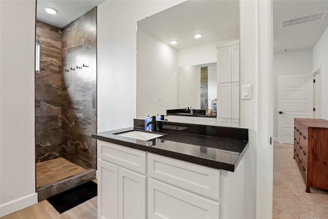 full bathroom featuring visible vents, vanity, and a walk in shower