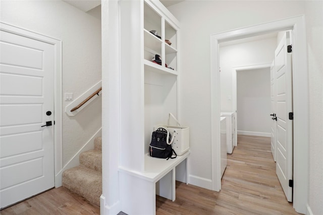 mudroom with light wood-style flooring and baseboards