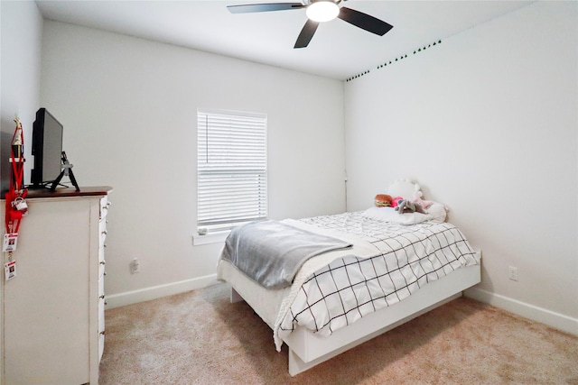 bedroom with light carpet, baseboards, and a ceiling fan