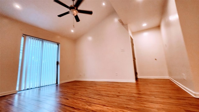 empty room with ceiling fan, light hardwood / wood-style floors, and high vaulted ceiling