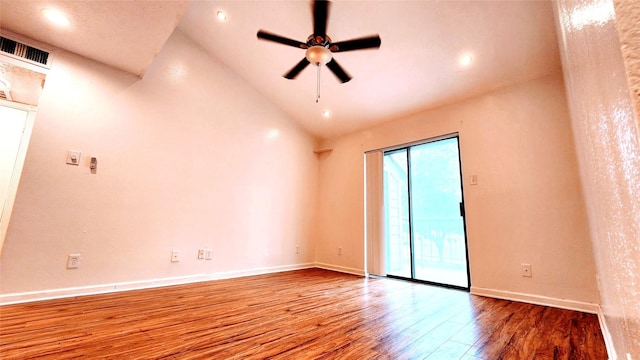 empty room featuring hardwood / wood-style floors, vaulted ceiling, and ceiling fan