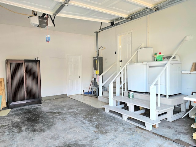 garage featuring a garage door opener, water heater, and independent washer and dryer