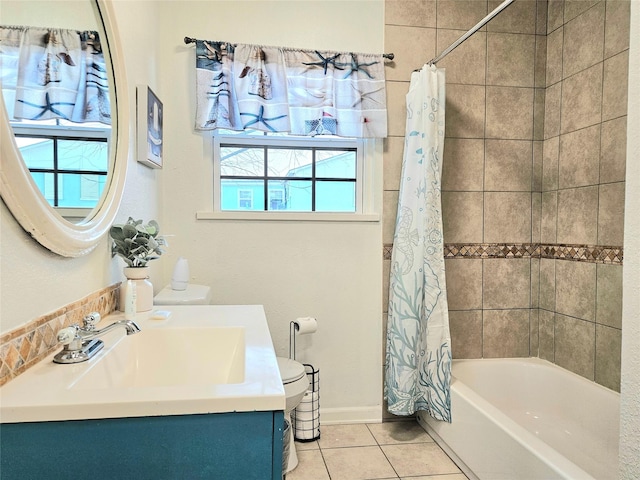 bathroom featuring tile patterned flooring, vanity, baseboards, and shower / bath combo with shower curtain