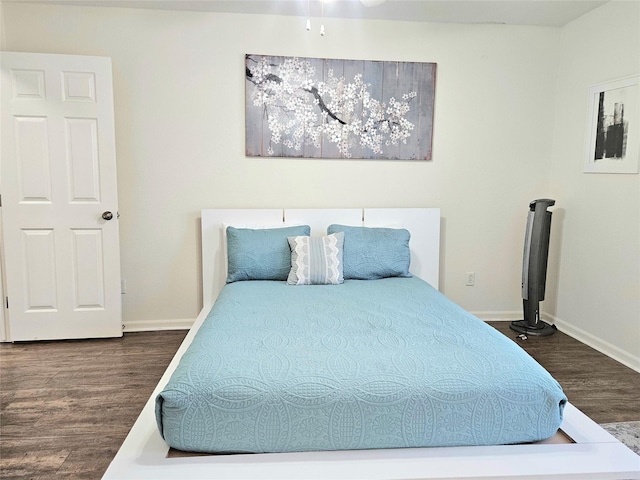 bedroom featuring dark wood-style flooring and baseboards