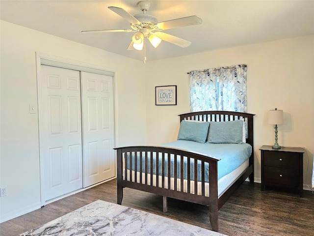 bedroom featuring ceiling fan, dark wood-type flooring, a closet, and baseboards