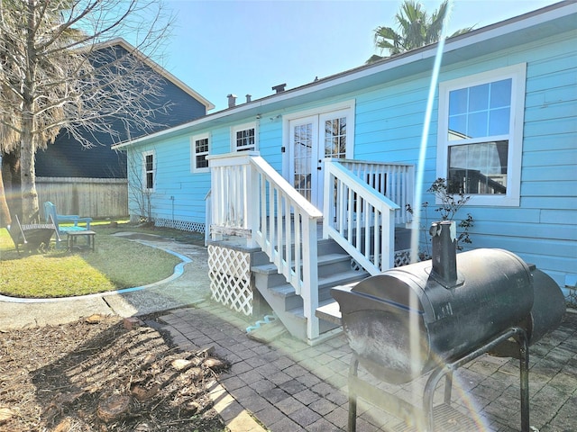 rear view of property featuring a patio area and fence