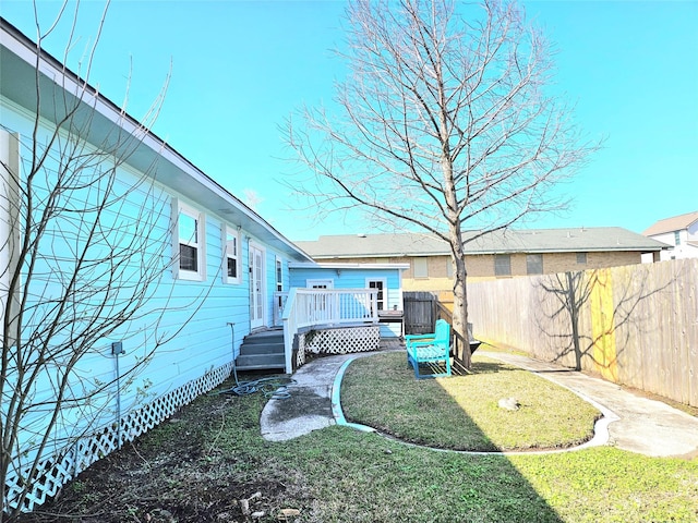 view of yard featuring a fenced backyard and a deck