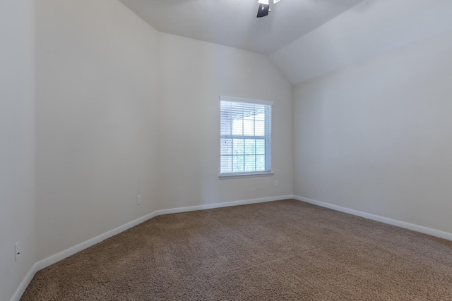 unfurnished room featuring ceiling fan, vaulted ceiling, and carpet