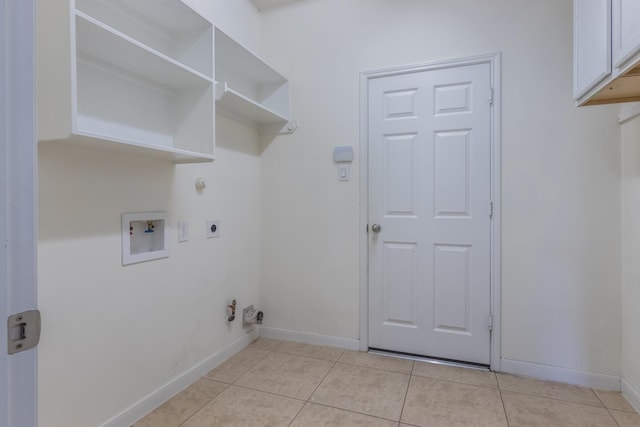 clothes washing area with hookup for a washing machine, light tile patterned flooring, gas dryer hookup, and electric dryer hookup