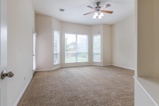 carpeted empty room featuring ceiling fan