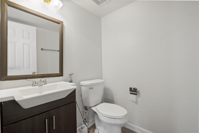 bathroom featuring toilet and vanity