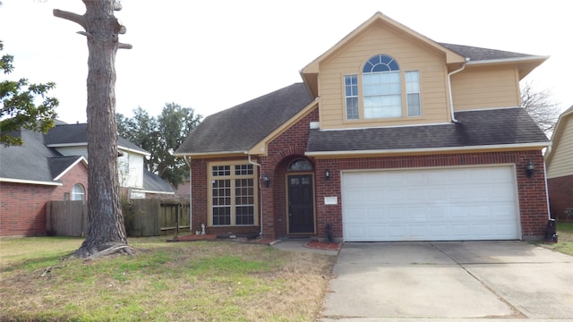 view of front of property with a front yard and a garage