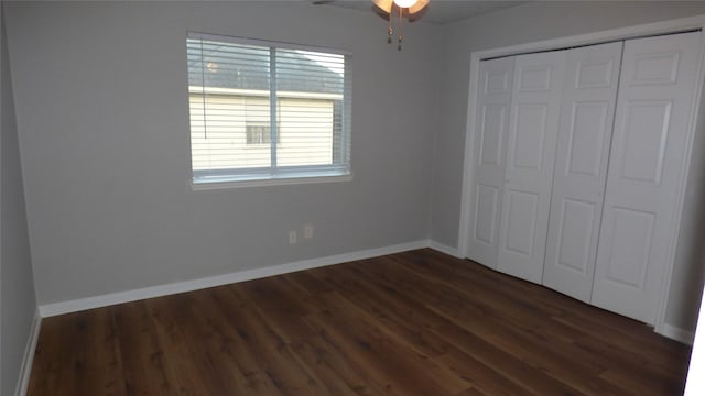 unfurnished bedroom featuring ceiling fan, dark hardwood / wood-style floors, and a closet