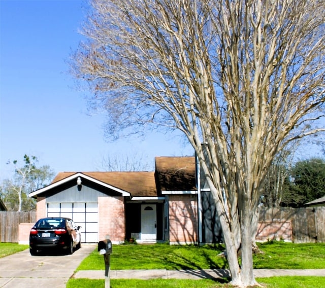 view of front of home featuring a garage and a front lawn