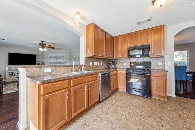 kitchen with sink, backsplash, a textured ceiling, ceiling fan, and black appliances