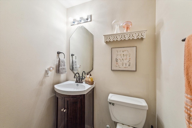 bathroom with toilet and vanity