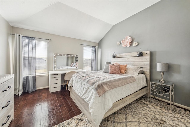 bedroom featuring multiple windows, vaulted ceiling, and dark wood-type flooring