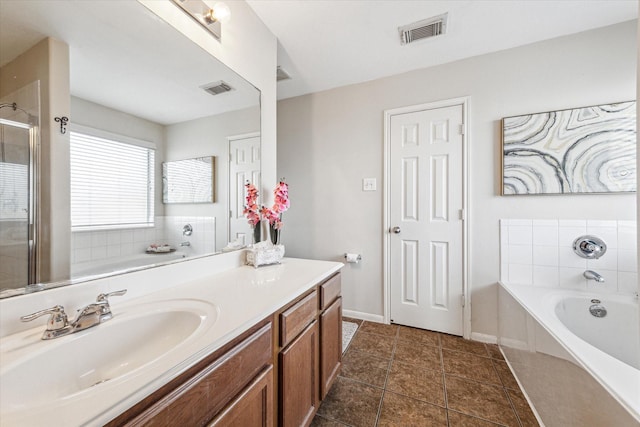 bathroom with vanity and independent shower and bath