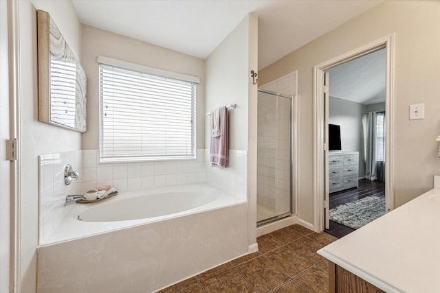 bathroom with shower with separate bathtub, tile patterned flooring, and vanity