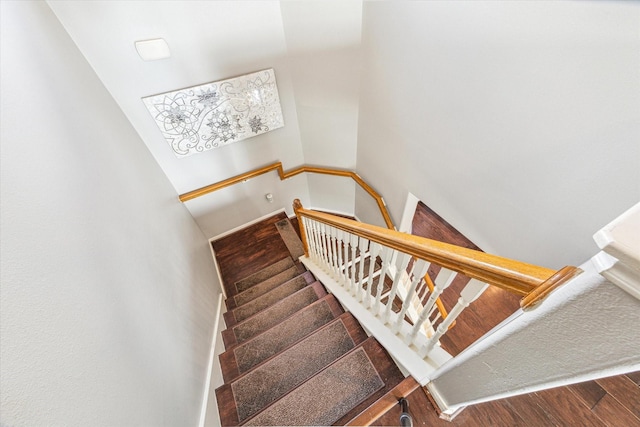 stairway with hardwood / wood-style flooring