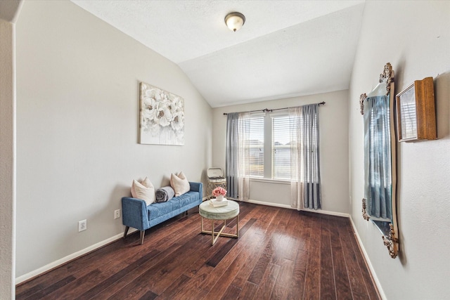 sitting room featuring lofted ceiling and dark hardwood / wood-style floors