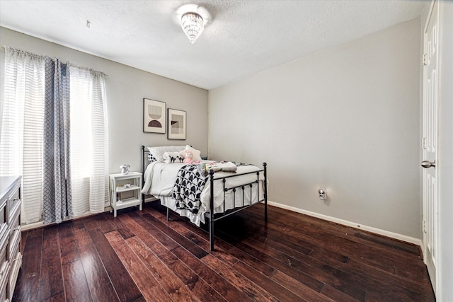 bedroom with hardwood / wood-style flooring and a textured ceiling