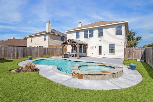 rear view of property with a yard, a patio, a pool with hot tub, and a gazebo