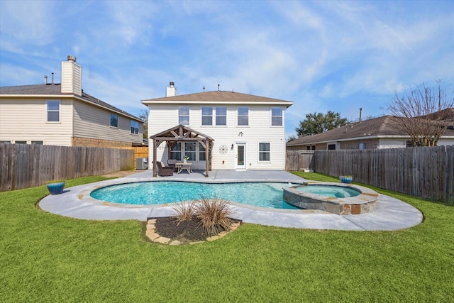 back of house with a swimming pool with hot tub, a yard, a gazebo, and a patio area