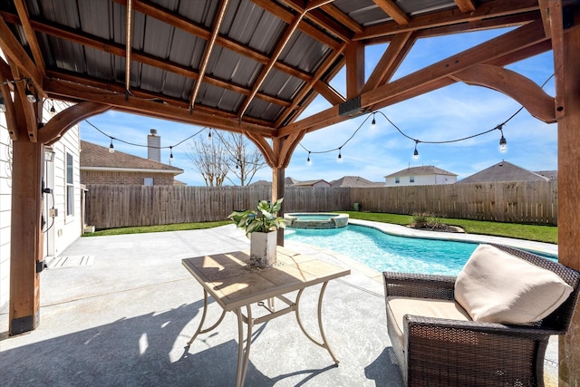 view of swimming pool with an in ground hot tub and a patio area