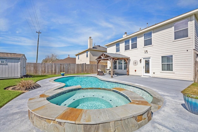 view of swimming pool featuring a storage shed, a patio, an in ground hot tub, and a gazebo