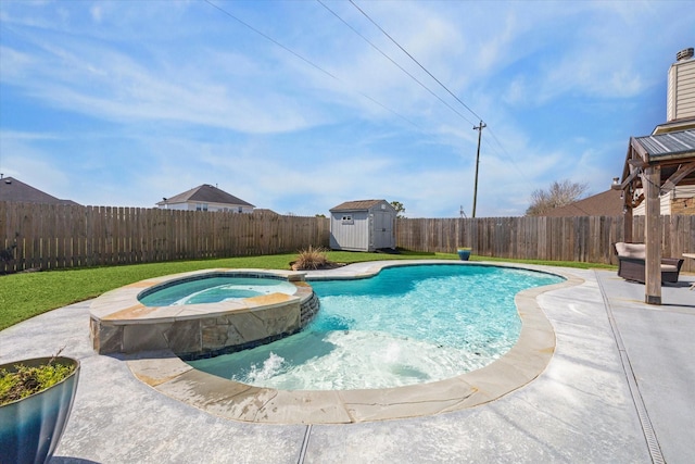 view of pool featuring an in ground hot tub, pool water feature, a patio area, and a shed