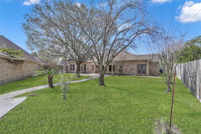 2715 Penmere Ct, Kingwood, TX 77345 - view of front of house featuring a fenced backyard and brick siding
