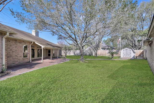 view of yard with a shed and a patio area