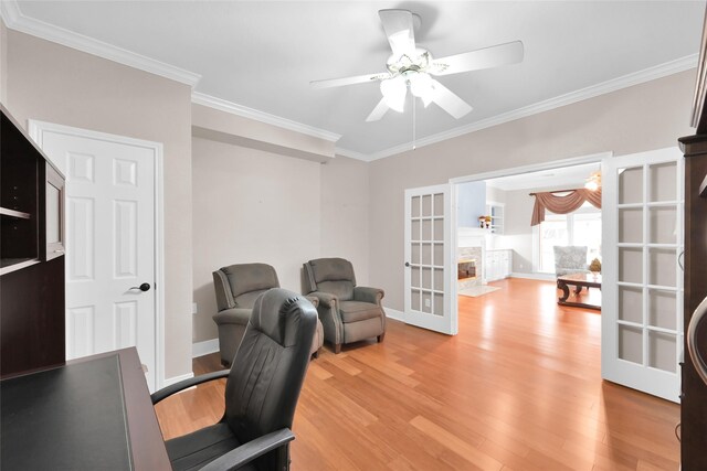office area with light wood-type flooring, french doors, a ceiling fan, crown molding, and baseboards