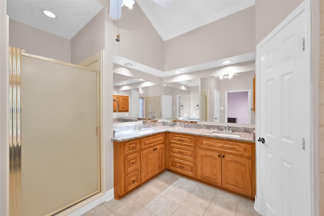 bathroom with a shower with shower door, tile patterned floors, ornamental molding, vaulted ceiling, and vanity