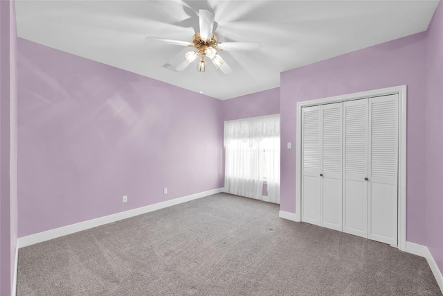 unfurnished bedroom featuring a closet, ceiling fan, and light colored carpet