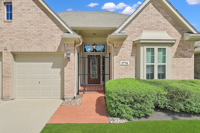 2715 Penmere Ct, Kingwood, TX 77345 - property entrance featuring brick siding, driveway, and a garage