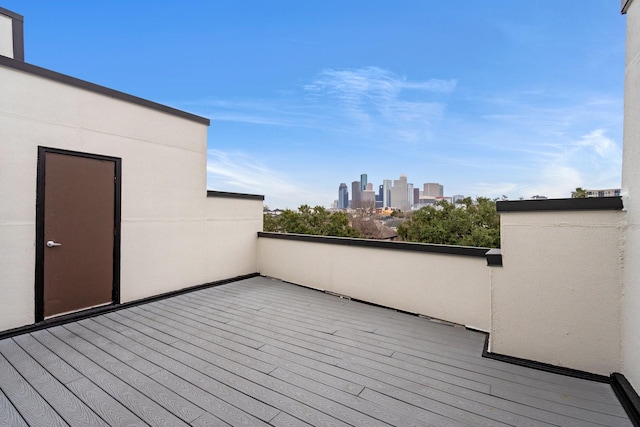 wooden terrace featuring a view of city