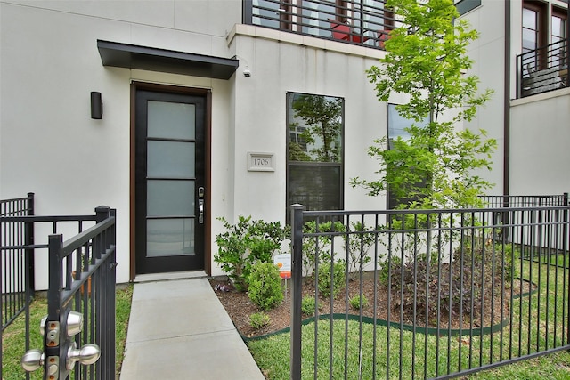 doorway to property featuring a yard